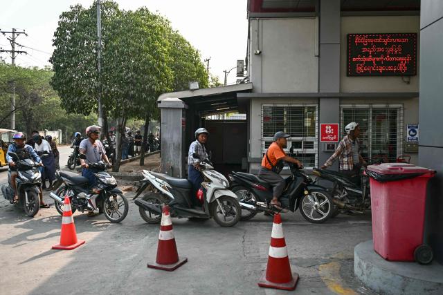 Motorists queue up at a petrol station amid rising prices in Mandalay on March 20, 2026. (Photo by Sai Aung MAIN / AFP)