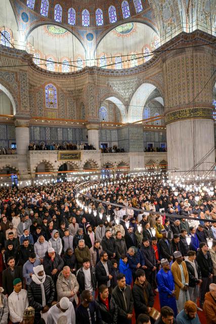 Muslim devotees attend the morning prayers celebrating the holiday of Eid al-Fitr, marking the end of the holy month of Ramadan, at the Blue Mosque, in Istanbul, on March 20, 2026. (Photo by Yasin AKGUL / AFP)
