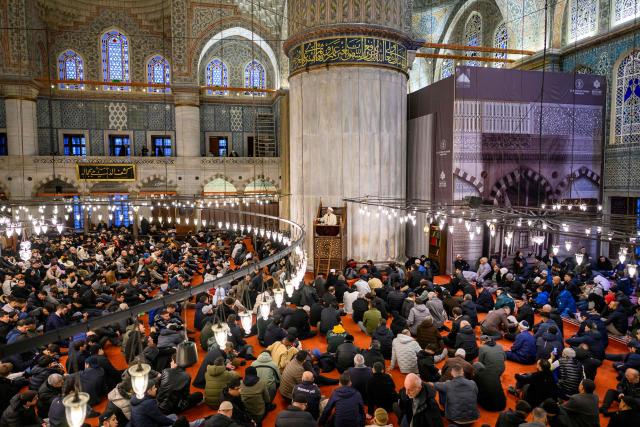 Muslim devotees attend the morning prayers celebrating the holiday of Eid al-Fitr, marking the end of the holy month of Ramadan, at the Blue Mosque, in Istanbul, on March 20, 2026. (Photo by Yasin AKGUL / AFP)