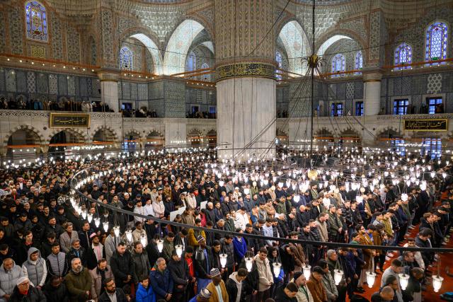 Muslim devotees attend the morning prayers celebrating the holiday of Eid al-Fitr, marking the end of the holy month of Ramadan, at the Blue Mosque, in Istanbul, on March 20, 2026. (Photo by Yasin AKGUL / AFP)