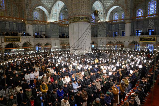 Muslim devotees attend the morning prayers celebrating the holiday of Eid al-Fitr, marking the end of the holy month of Ramadan, at the Blue Mosque, in Istanbul, on March 20, 2026. (Photo by Yasin AKGUL / AFP)