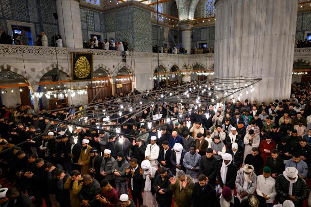 Muslim devotees attend the morning prayers celebrating the holiday of Eid al-Fitr, marking the end of the holy month of Ramadan, at the Blue Mosque, in Istanbul, on March 20, 2026. (Photo by Yasin AKGUL / AFP)