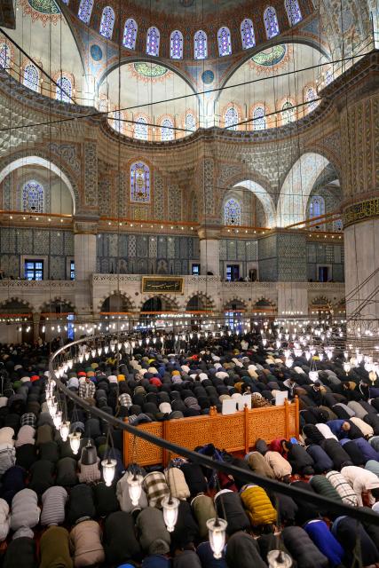 Muslim devotees attend the morning prayers celebrating the holiday of Eid al-Fitr, marking the end of the holy month of Ramadan, at the Blue Mosque, in Istanbul, on March 20, 2026. (Photo by Yasin AKGUL / AFP)
