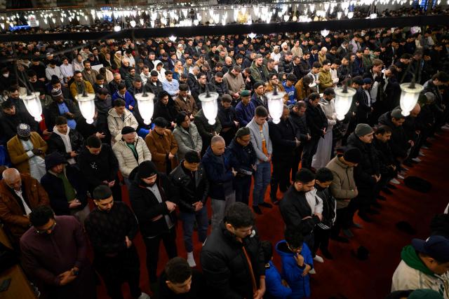 Muslim devotees attend the morning prayers celebrating the holiday of Eid al-Fitr, marking the end of the holy month of Ramadan, at the Blue Mosque, in Istanbul, on March 20, 2026. (Photo by Yasin AKGUL / AFP)
