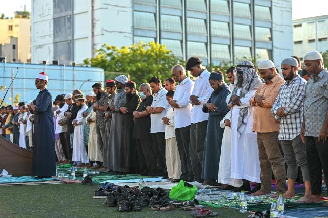 Maldives' President Mohamed Muizzu (C) offers Eid al-Fitr prayers, which marks the end of the Islamic holy fasting month of Ramadan, in Male on March 20, 2026. (Photo by Mohamed Afrah / AFP)