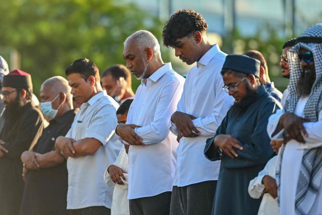 Maldives' President Mohamed Muizzu (C) offers Eid al-Fitr prayers, which marks the end of the Islamic holy fasting month of Ramadan, in Male on March 20, 2026. (Photo by Mohamed Afrah / AFP)