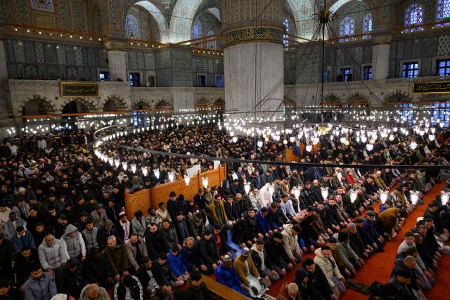 Muslim devotees attend the morning prayers celebrating the holiday of Eid al-Fitr, marking the end of the holy month of Ramadan, at the Blue Mosque, in Istanbul, on March 20, 2026. (Photo by Yasin AKGUL / AFP)