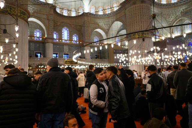 Muslim devotees attend the morning prayers celebrating the holiday of Eid al-Fitr, marking the end of the holy month of Ramadan, at the Blue Mosque, in Istanbul, on March 20, 2026. (Photo by Yasin AKGUL / AFP)