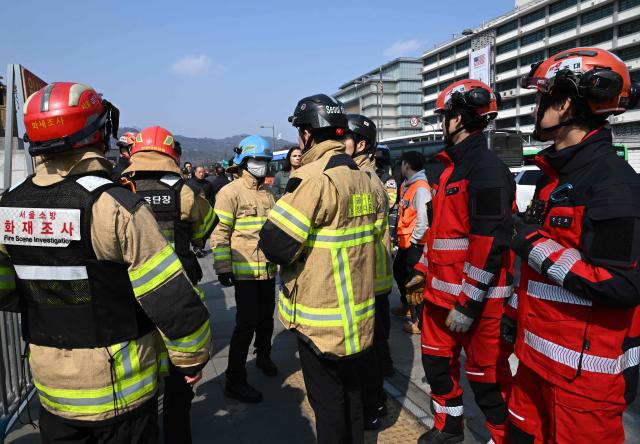 Firefighters check safety at the venue for the comeback concert of K-pop boy group BTS at Gwanghwamun Square in Seoul on March 20, 2026. K-pop megastars BTS released a new album on March 20, billed as reflecting the maturing boy band's Korean roots and identity, as buzz built ahead of their open-air comeback concert in the heart of Seoul. (Photo by Jung Yeon-je / AFP)