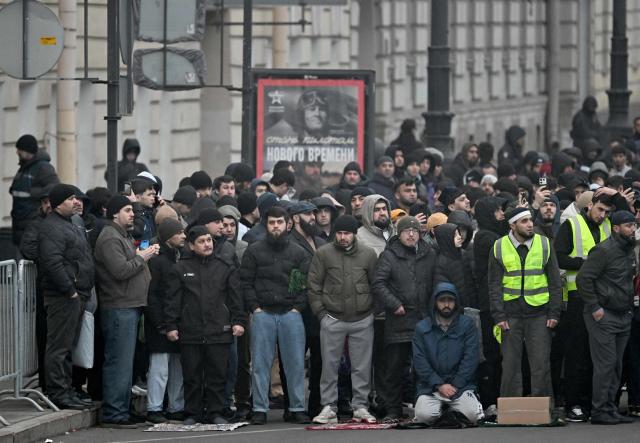 Muslim worshippers perform the early morning prayers for Eid al-Fitr, marking the end of the holy month of Ramadan, on a street in Saint Petersburg on March 20, 2026. (Photo by Olga MALTSEVA / AFP)