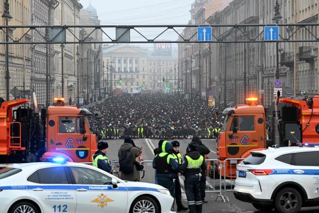 Muslim worshippers perform the early morning prayers for Eid al-Fitr, marking the end of the holy month of Ramadan, on a street in Saint Petersburg on March 20, 2026. (Photo by Olga MALTSEVA / AFP)