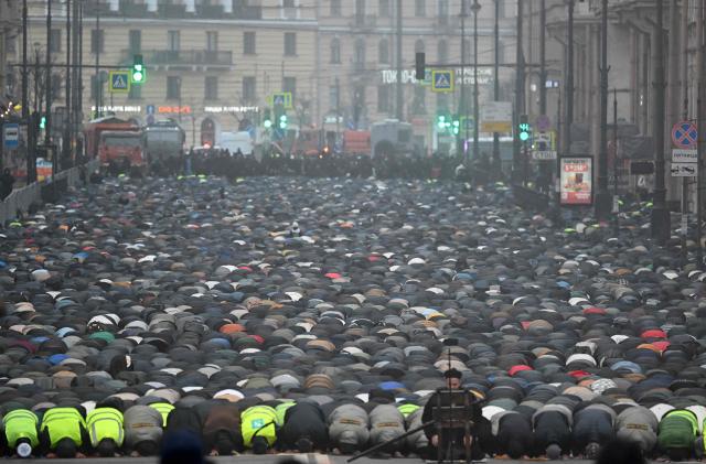 Muslim worshippers perform the early morning prayers for Eid al-Fitr, marking the end of the holy month of Ramadan, on a street in Saint Petersburg on March 20, 2026. (Photo by Olga MALTSEVA / AFP)