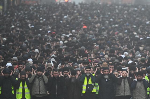 Muslim worshippers perform the early morning prayers for Eid al-Fitr, marking the end of the holy month of Ramadan, on a street in Saint Petersburg on March 20, 2026. (Photo by Olga MALTSEVA / AFP)