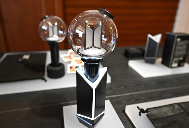BTS' light stick 'Army Bomb' is displayed at a BTS pop-up store at Shinsegae Department Store's The Heritage in Seoul on March 20, 2026. K-pop megastars BTS released a new album on March 20, billed as reflecting the maturing boy band's Korean roots and identity, as buzz built ahead of their open-air comeback concert in the heart of Seoul. (Photo by Jung Yeon-je / AFP)