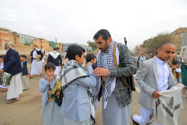 Yemenis exchange greetings after the morning Eid al-Fitr prayers, which marks the end of the holy fasting month of Ramadan, in the capital Sanaa on March 20, 2026. (Photo by Mohammed HUWAIS / AFP)