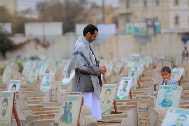A Yemeni visits a cemetery to pray over the grave of relatives after the morning Eid al-Fitr prayers, which marks the end of the holy fasting month of Ramadan, in the capital Sanaa on March 20, 2026. (Photo by Mohammed HUWAIS / AFP)