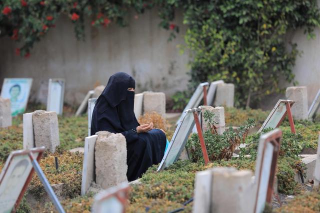 A Yemeni visits a cemetery as she prays over the grave of her relative after the morning Eid al-Fitr prayers, which marks the end of the holy fasting month of Ramadan, in the capital Sanaa on March 20, 2026. (Photo by Mohammed HUWAIS / AFP)
