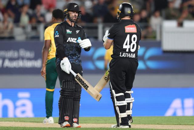 New Zealand’s Devon Conway (L) speaks with Tom Latham during the third Twenty20 international cricket match between New Zealand and South Africa at Eden Park in Auckland on March 20, 2026. (Photo by Michael Bradley / AFP)