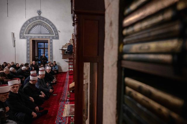 Muslim devotees attend the morning prayers for Eid al-Fitr which marks the end of the holy fasting month of Ramadan, at the Grand Mosque of Pristina on March 20, 2026. (Photo by Armend NIMANI / AFP)