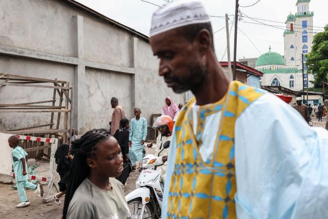 Muslims leave the Grand Mosque in Brazzaville, at the end of the Eid al-Fitr prayer on March 20, 2026. (Photo by Daniel BELOUMOU OLOMO / AFP)