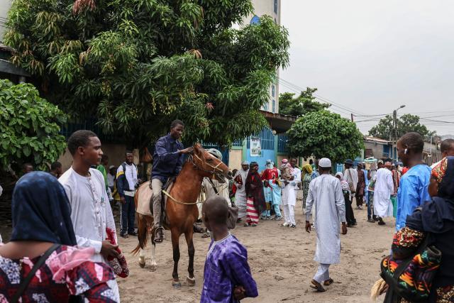 TOPSHOT - A man rides his horse near the Grand Mosque in Brazzaville, at the end of the Eid al-Fitr prayer on March 20, 2026. (Photo by Daniel BELOUMOU OLOMO / AFP)