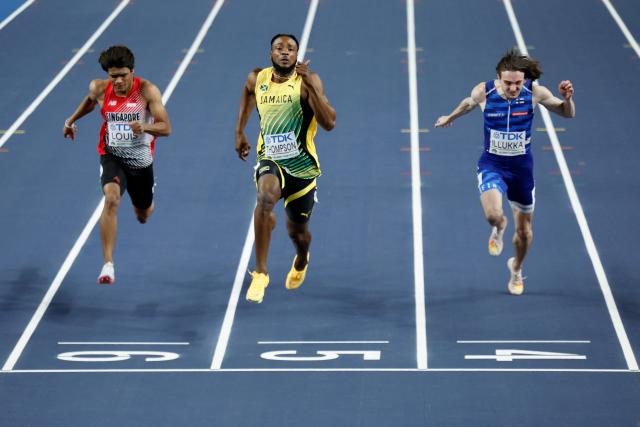 Jamaica's Kishane Thompson (C) competes to win ahead of Singapore's Marc Brian Louis (L) and Finland's Riku Illukka (R) during the men's heats 60 metres heat 5 during the World Athletics Indoor Championships Kujawy Pomorze 2026 in Torun, Poland on March 20, 2026. (Photo by Wojtek RADWANSKI / AFP)