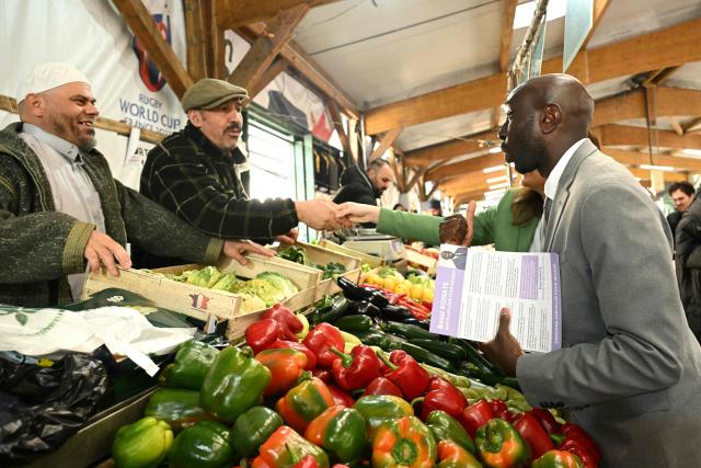 Sarcelles independent mayoral candidate Bassi Konate campaigns in a market ahead of the second round of France's 2026 municipal elections in Sarcelles, a northern Paris suburb, on March 20, 2026. French voters head to the pools on March 22, 2026, for the second round of municipal elections. (Photo by Bertrand GUAY / AFP)
