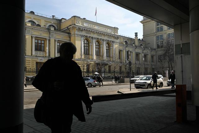 A man walks past the Russian Central Bank headquarters in Neglinnaya street in central Moscow on March 20, 2026. Russia's central bank on March 20, 2026 cut its key interest rate to 15 percent from 15.5 percent as the economy slows under pressure from Moscow's protracted and expensive war in Ukraine and Western sanctions. (Photo by Igor IVANKO / AFP)
