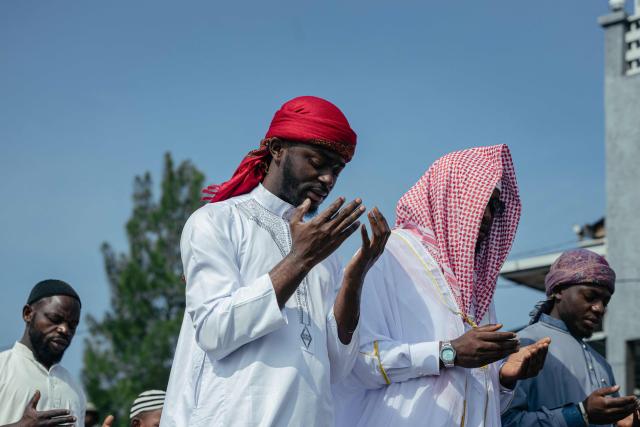 Muslim devotees offer Eid al-Fitr prayers, marking the end of the holy month of Ramadan, at Unity Stadium in Goma on March 20, 2026. (Photo by Jospin Mwisha / AFP)