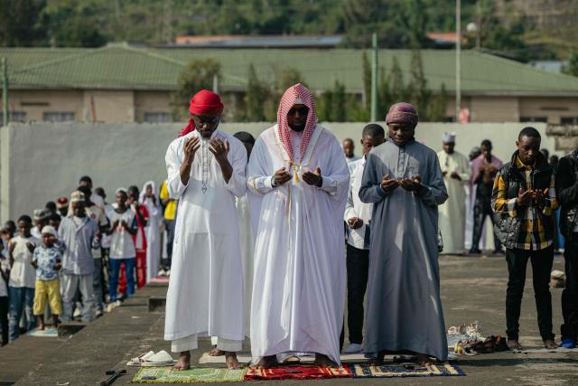 Muslim devotees offer Eid al-Fitr prayers, marking the end of the holy month of Ramadan, at Unity Stadium in Goma on March 20, 2026. (Photo by Jospin Mwisha / AFP)