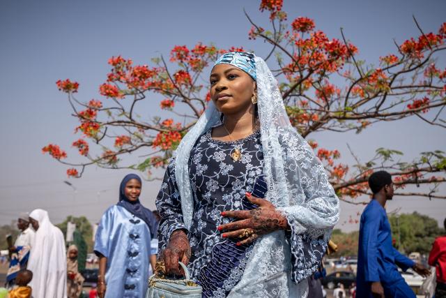 A Muslim devotee poses for a group photo after Eid al-Fitr prayers, marking the end of the holy month of Ramadan, at the National Eid prayer ground in Abuja on March 20, 2026. (Photo by Light Oriye Tamunotonye / AFP)