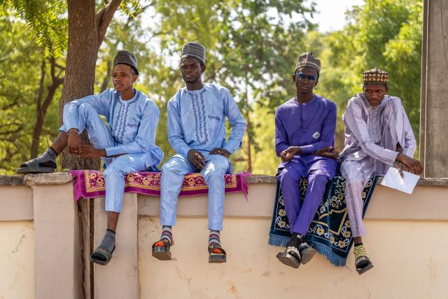 Muslim devotees pose for a group photo after Eid al-Fitr prayers, marking the end of the holy month of Ramadan, at the National Eid prayer ground in Abuja on March 20, 2026. (Photo by Light Oriye Tamunotonye / AFP)