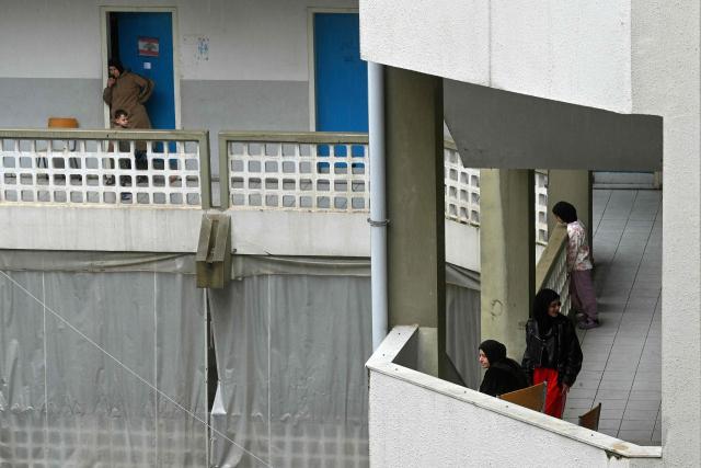 Displaced families from southern Lebanon stand in the alleys of a school turned into a shelter in Beirut on March 20, 2026. Lebanon was pulled into the regional war on March 2, when Hezbollah fired rockets toward neighbouring Israel in response to the killing of its ally Iran's supreme leader in Israeli-US attacks. Israel responded with heavy airstrikes across Lebanon and ground incursions in the border area. (Photo by FADEL itani / AFP)