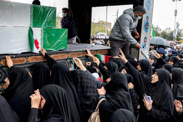 Mourners bid farewell to the bodies of Iran's slain intelligence minister Esmail Khatib and his family during their funeral after the weekly Friday noon prayers in Tehran on March 20, 2026. Israel's military said on March 18 that it would not stop its "series of eliminations" of senior Iranian officials, after announcing it had killed Khatib. His killing came soon after Israel killed Iran's powerful security chief Ali Larijani. (Photo by AFP)