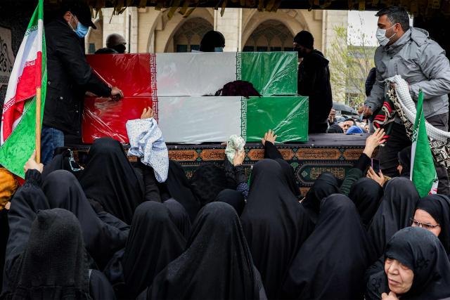 Mourners bid farewell to the bodies of Iran's slain intelligence minister Esmail Khatib and his family during their funeral after the weekly Friday noon prayers in Tehran on March 20, 2026. Israel's military said on March 18 that it would not stop its "series of eliminations" of senior Iranian officials, after announcing it had killed Khatib. His killing came soon after Israel killed Iran's powerful security chief Ali Larijani. (Photo by AFP)