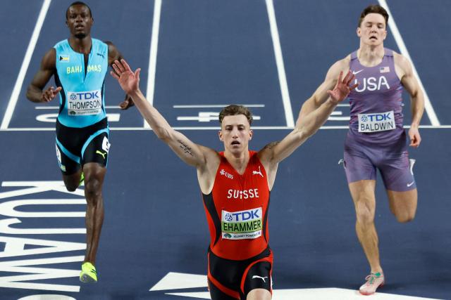 TOPSHOT - Switzerland's Simon Ehammer (C) wins ahead of Bahamas' Kendrick Thompson and USA's Heath Baldwin after the men's heats 60 metres heat 2 during the World Athletics Indoor Championships Kujawy Pomorze 2026 in Torun, Poland on March 20, 2026. (Photo by Wojtek RADWANSKI / AFP)
