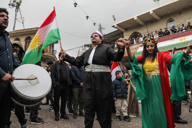 Iraqi Kurds celebrate the new year spring festival of Nowruz in the town of Akre, north of Erbil in Iraq's northern autonomous Kurdish region, on March 20, 2026. Millions of people across the Middle East, Asia and Eastern Europe celebrate Nowruz new year festival, which marks the start of spring. (Photo by Safin HAMID / AFP)