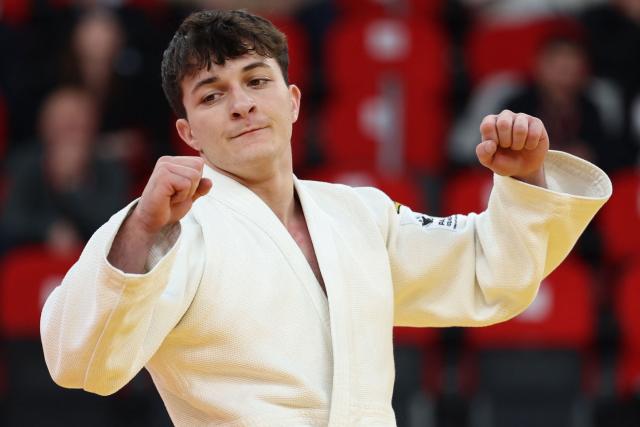 Israel's Izhak Ashpiz (white) wins against Russia's Achyty Dombuu in the men's under 60 kg final bout at the Tbilisi Grand Slam judo tournament in Tbilisi on March 20, 2026. (Photo by Giorgi ARJEVANIDZE / AFP)