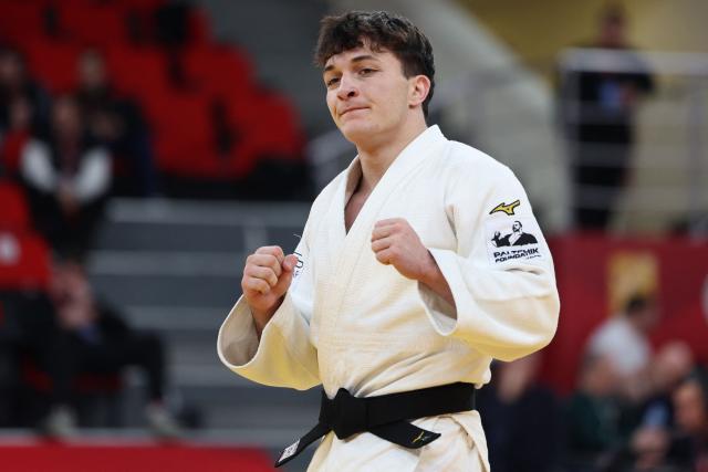 Israel's Izhak Ashpiz (white) wins against Russia's Achyty Dombuu in the men's under 60 kg final bout at the Tbilisi Grand Slam judo tournament in Tbilisi on March 20, 2026. (Photo by Giorgi ARJEVANIDZE / AFP)