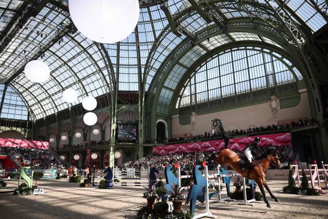 Liechtenstein's Jennifer Hochstaedter riding Moeboetoe V/D Roshoeve competes during the "Prix du Grand Palais" of "Le Saut Hermès" horse International Jumping Competition at the Grand Palais in Paris, on March 20, 2026. (Photo by Anne-Christine POUJOULAT / AFP)