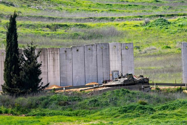 An Israeli tank is stationary on the Israeli side of the border fence with Lebanon in the Upper Galilee in northern Israel on March 20, 2026. The United States and Israel began the war on February 28, 2026, by attacking Iran and killing its supreme leader. Iran retaliated with strikes against Israel and US allies and interests across the Gulf and Iraq, drawing the whole region into war. Lebanon was drawn into the conflict on March 2 when Hezbollah militants launched rockets at Israel after the killing of the Iranian supreme leader. (Photo by Odd ANDERSEN / AFP)