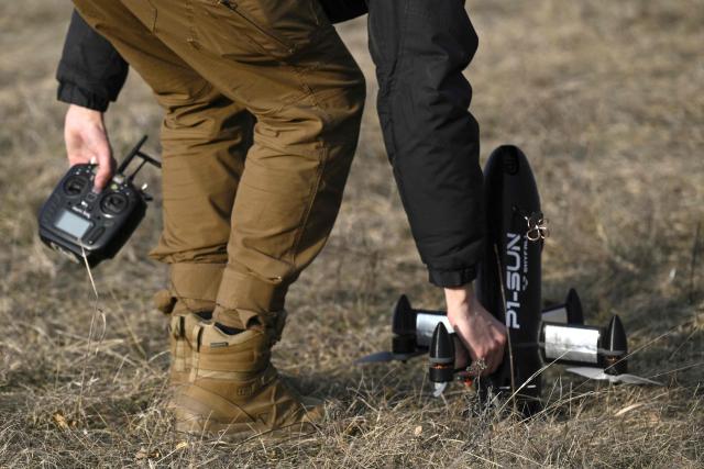 An employee of the Ukrainian SkyFall company prepares a P1-Sun interceptor drone for a test flight at an undisclosed location in Ukraine on March 19, 2026, amid the Russian invasion of Ukraine. (Photo by Genya SAVILOV / AFP)