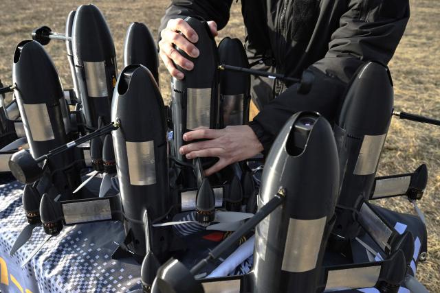 An employee of the Ukrainian SkyFall company checks a P1-Sun interceptor drone before a test flight at an undisclosed location in Ukraine on March 19, 2026, amid the Russian invasion of Ukraine. (Photo by Genya SAVILOV / AFP)
