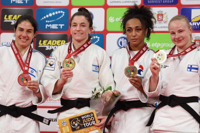 Silver medallist Israel's Inbal Shemesh, gold medallist Israel's Timna Nelson Levy and bronze medallists France's Martha Fawaz and Finland's Pihla Salonen pose with their medals during a ceremony for the women's under 57 kg event at the Tbilisi Grand Slam judo tournament in Tbilisi on March 20, 2026. (Photo by Giorgi ARJEVANIDZE / AFP)