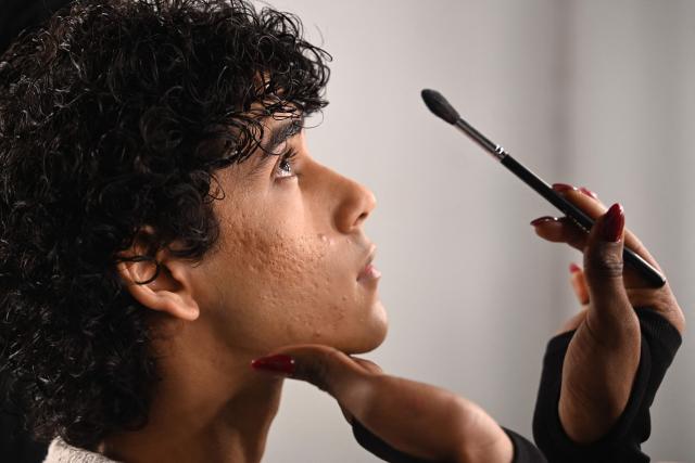 A model wears makeup backstage at the Lakme Fashion Week (LFW) in Mumbai on March 20, 2026. (Photo by SUJIT JAISWAL / AFP)