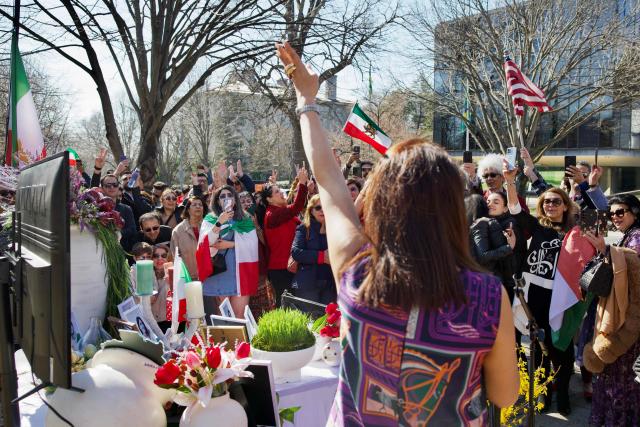 Iranian residents from the Washington, DC, area gather outside the former Embassy of Iran to mark the Persian New Year, Nowruz, at the moment of the new year on March 20, 2026, in Washington, DC. Iranian families in the Washington, DC, area are trying to maintain cultural traditions while following the news of the ongoing conflict in Iran. From specialty Persian markets to community gatherings, preparations continue with a mix of resilience and concern, as the diaspora balances celebration with anxiety for loved ones in a country facing escalating violence. (Photo by Amid FARAHI / AFP)