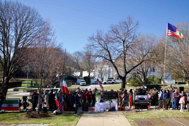 Iranian residents of Washington, DC, gather outside the former Embassy of Iran to mark the Persian New Year, Nowruz, at the moment of the new year on March 20, 2026, in Washington, DC. Iranian families in the Washington, DC, area are trying to maintain cultural traditions while following the news of the ongoing conflict in Iran. From specialty Persian markets to community gatherings, preparations continue with a mix of resilience and concern, as the diaspora balances celebration with anxiety for loved ones in a country facing escalating violence. (Photo by Amid FARAHI / AFP)