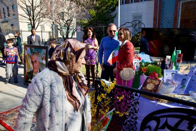 Iranian residents from the Washington, DC, area gather outside the former Embassy of Iran to mark the Persian New Year, Nowruz, at the moment of the new year on March 20, 2026, in Washington, DC. Iranian families in the Washington, DC, area are trying to maintain cultural traditions while following the news of the ongoing conflict in Iran. From specialty Persian markets to community gatherings, preparations continue with a mix of resilience and concern, as the diaspora balances celebration with anxiety for loved ones in a country facing escalating violence. (Photo by Amid FARAHI / AFP)