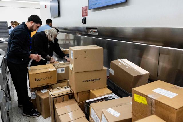Boxes of medical supplies from the Nuestra America Convoy are inspected and labeled during check-in and loading at Miami International Airport in Miami, Florida, on March 20, 2026, ahead of the delegation traveling to Cuba with humanitarian aid. The group will bring 6,300 pounds of medicine and medical supplies to Cuba, who is experiencing shortages. Cuba has been mired in an economic crisis exacerbated by the sudden suspension of oil supplies from Venezuela in January after the United States ousted president Nicolas Maduro, a Cuba ally. (Photo by Eva Marie UZCATEGUI / AFP)