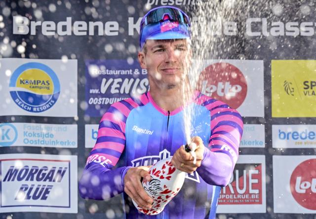 Unibet Rose Rockets' Dutch rider Dylan Groenewegen celebrates on the podium after winning the 'Bredene Koksijde Classic' one day cycling race, 203.4 km from Bredene to Koksijde, on March 20, 2026. (Photo by DIRK WAEM / Belga / AFP) / Belgium OUT